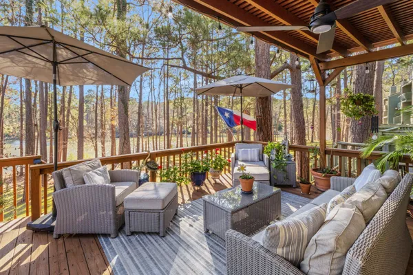a balcony with furniture and wooden floor