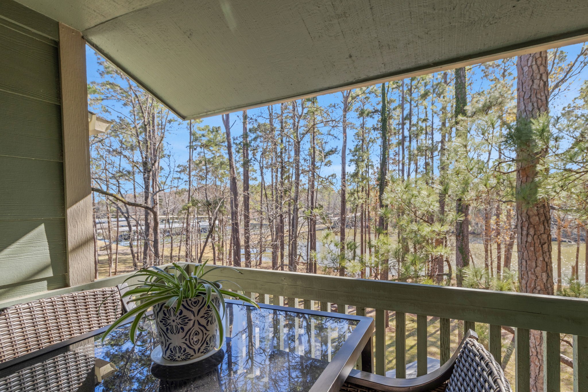 154 Villa Way Coldspring, TX 77331 - Photo 20 of 42 The covered primary balcony offers a comfortable spot to sit and enjoy the view, even on rainy days