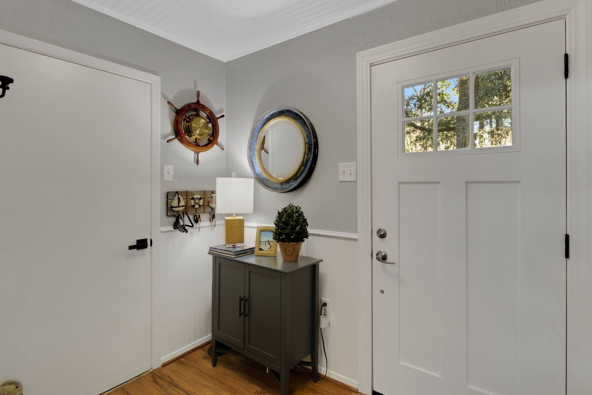 154 Villa Way Coldspring, TX 77331 - Photo 3 of 42 Welcome home! The entrance hallway features wainscoting, luxury vinyl plank flooring and cool, lake colors