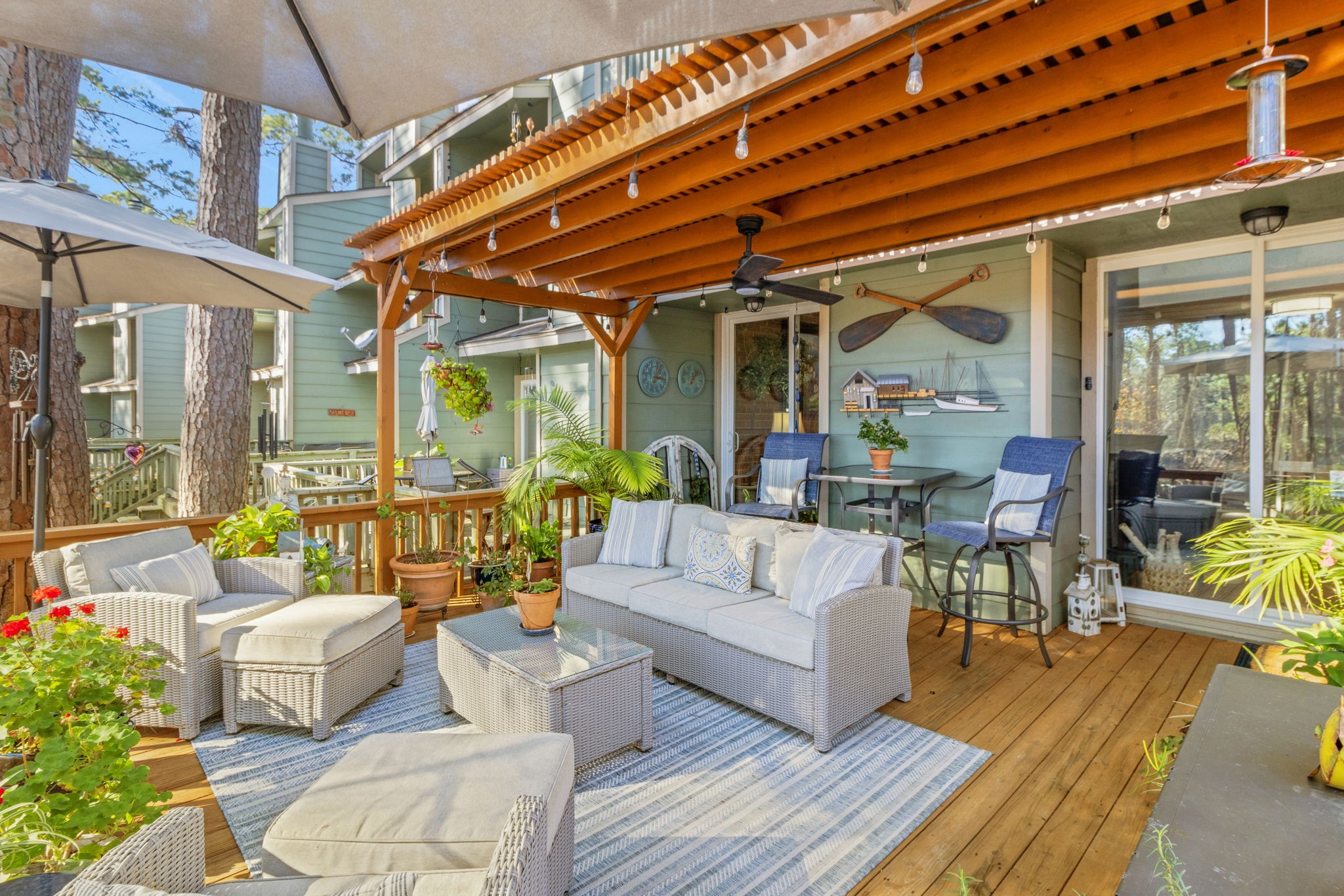 154 Villa Way Coldspring, TX 77331 - Photo 7 of 42 The back deck is enhanced by the pergola, ideal for shaded outdoor enjoyment