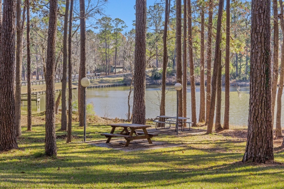 154 Villa Way Coldspring, TX 77331 - Photo 10 of 42 The back deck leads down to a communal space by the lagoon where you can picnic, fish or just enjoy the wildlife