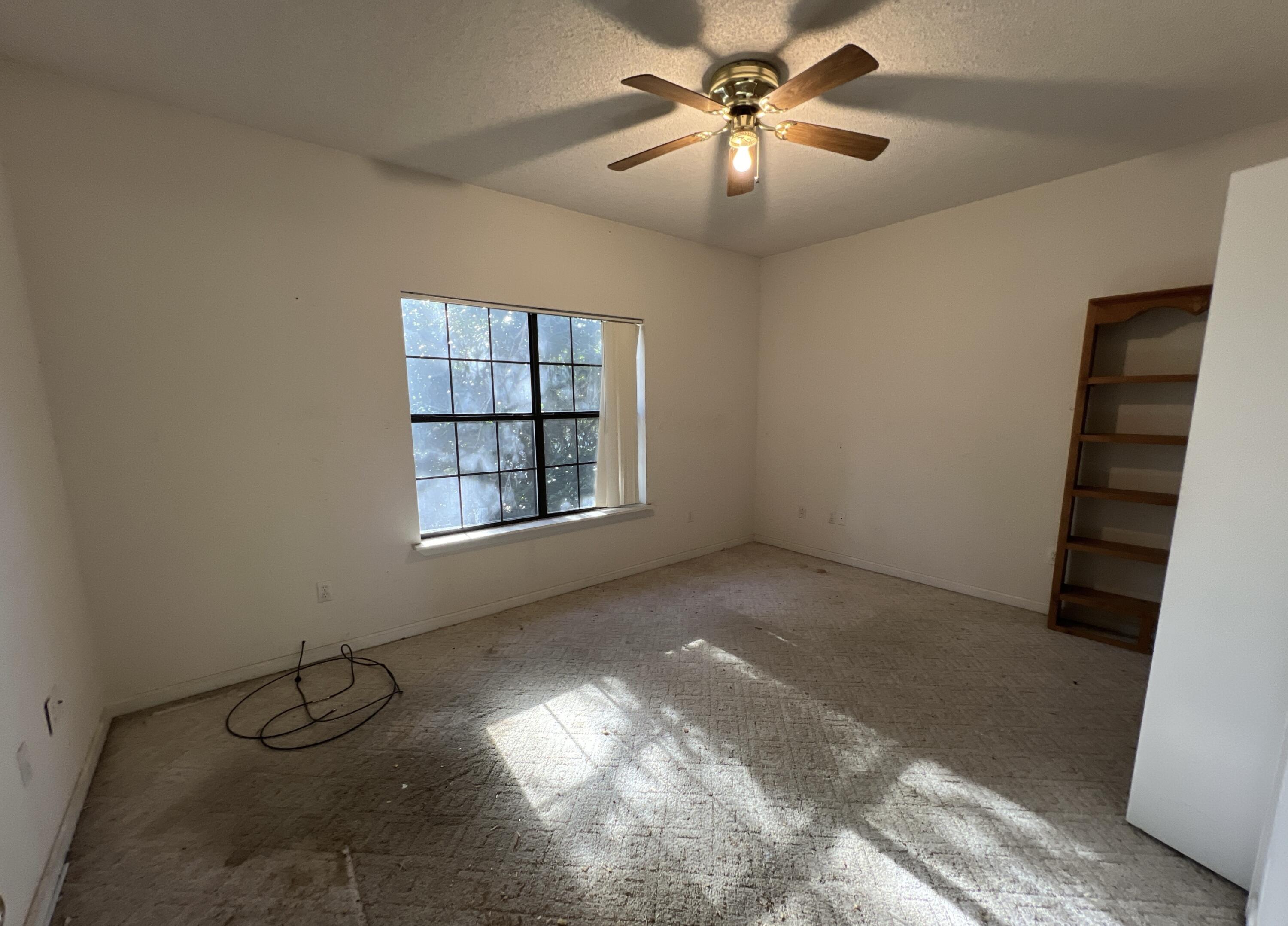 4746 Pebble Creek Drive Pensacola, FL 32526 - Photo 13 of 23 an empty room with windows and ceiling fan
