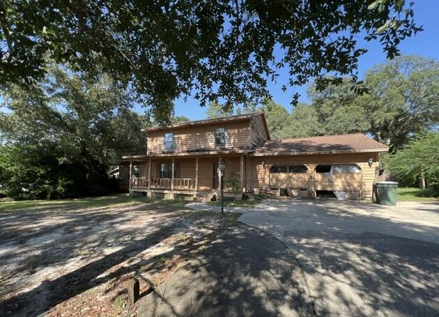 4746 Pebble Creek Drive Pensacola, FL 32526 - Photo 17 of 23 a view of a big house with a tree in the background