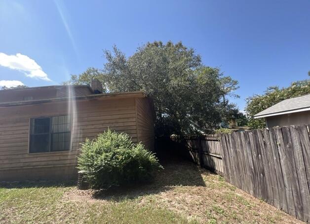 4746 Pebble Creek Drive Pensacola, FL 32526 - Photo 18 of 23 a view of backyard with potted plants and wooden fence