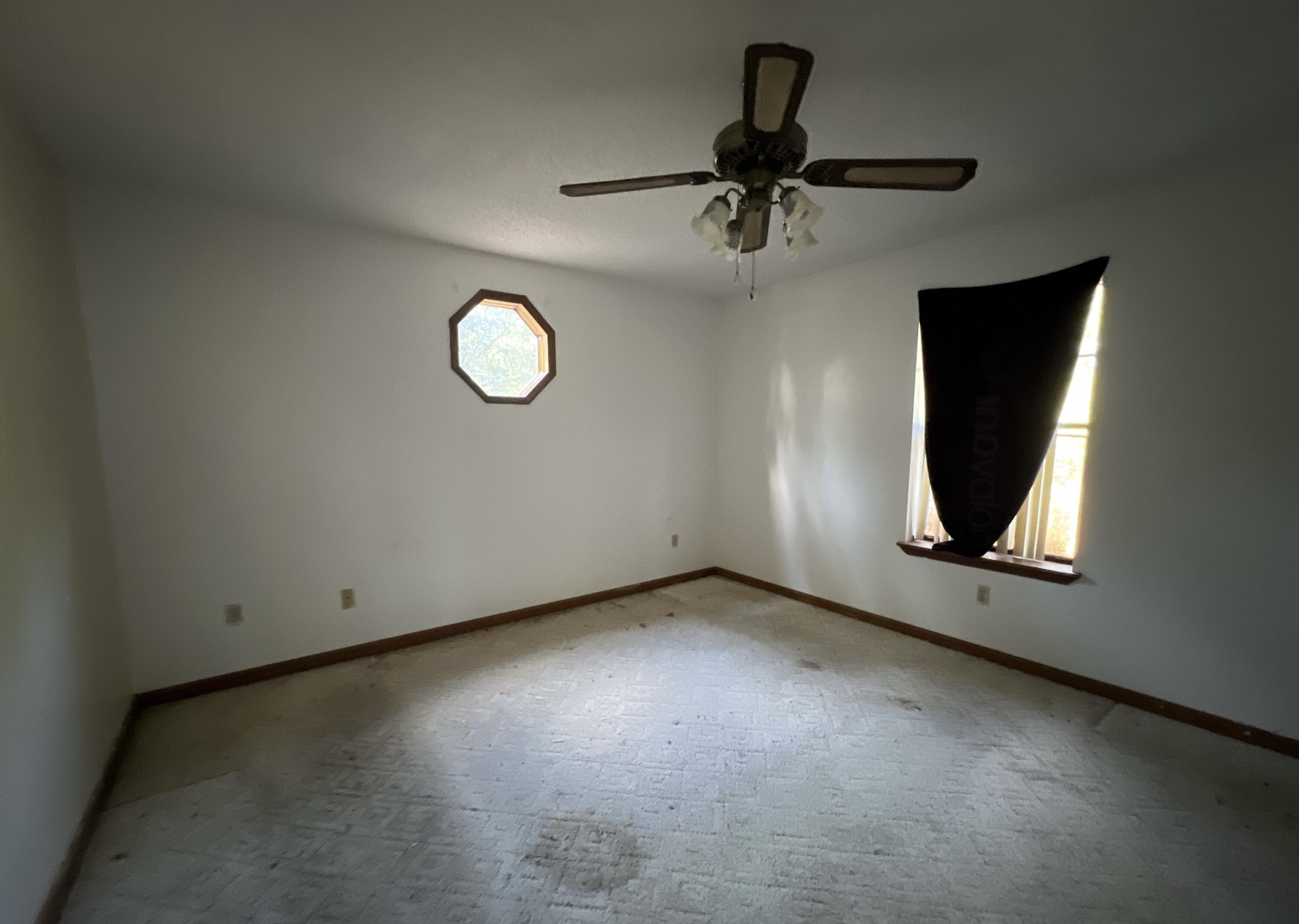 4746 Pebble Creek Drive Pensacola, FL 32526 - Photo 23 of 23 an empty room with a fan and a window