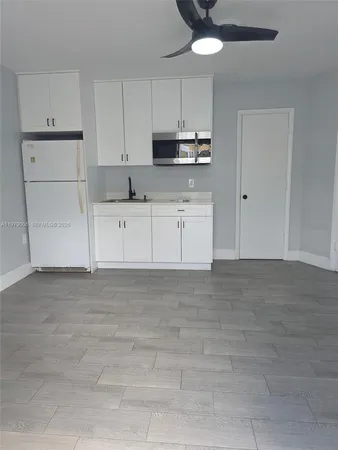a kitchen with cabinets stainless steel appliances and a counter space