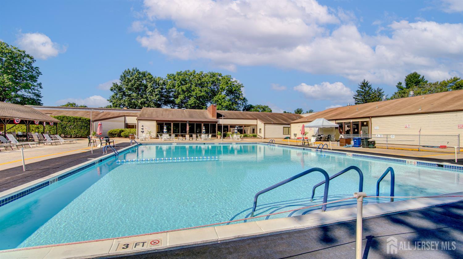 86 Arrowood Road, Unit G Manalapan, NJ 07726 - Photo 15 of 16 a view of a swimming pool with a deck