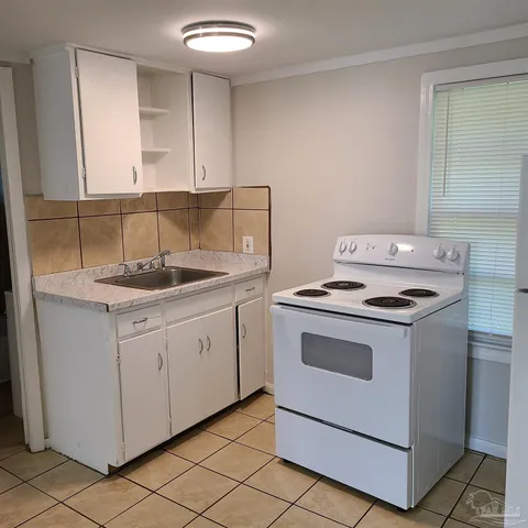 a kitchen with granite countertop cabinets stainless steel appliances and a sink