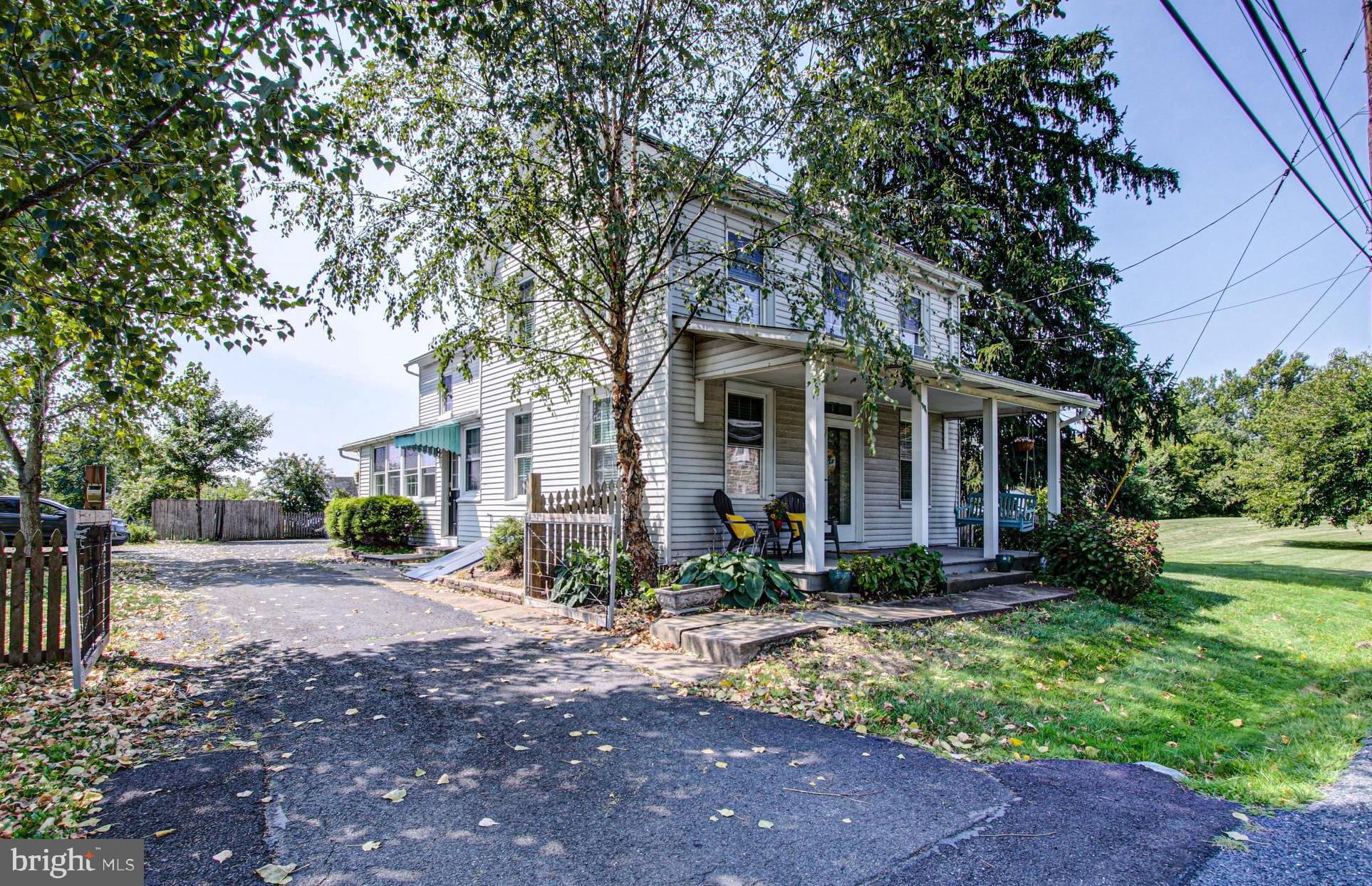 1079 Old Skippack Road Harleysville, PA 19438 - Photo 1 of 53 a front view of a house with garden