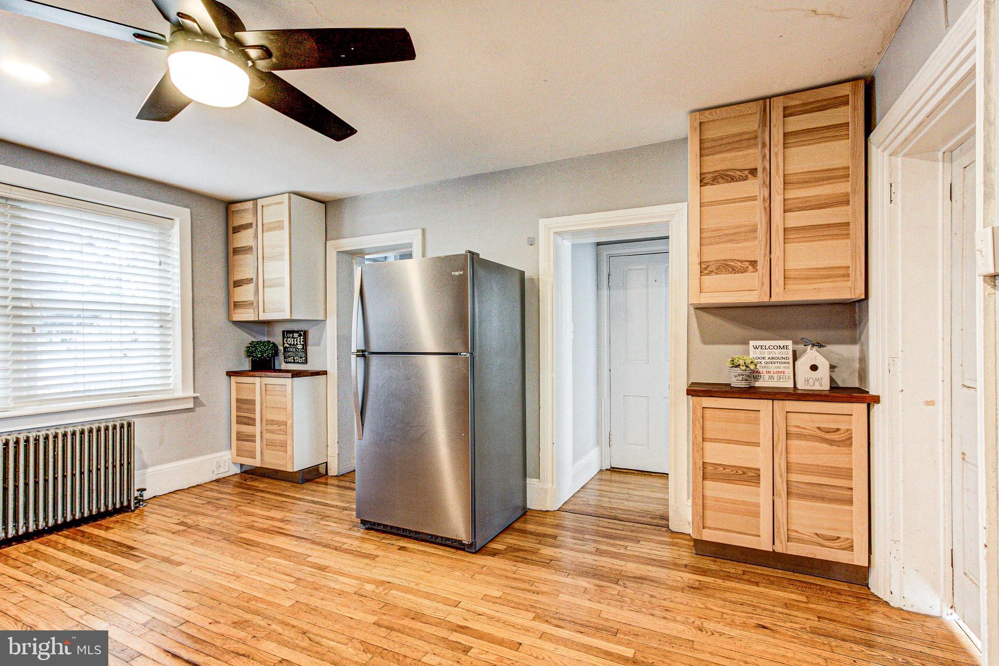 1079 Old Skippack Road Harleysville, PA 19438 - Photo 17 of 53 a kitchen with a refrigerator a stove cabinets and wooden floor
