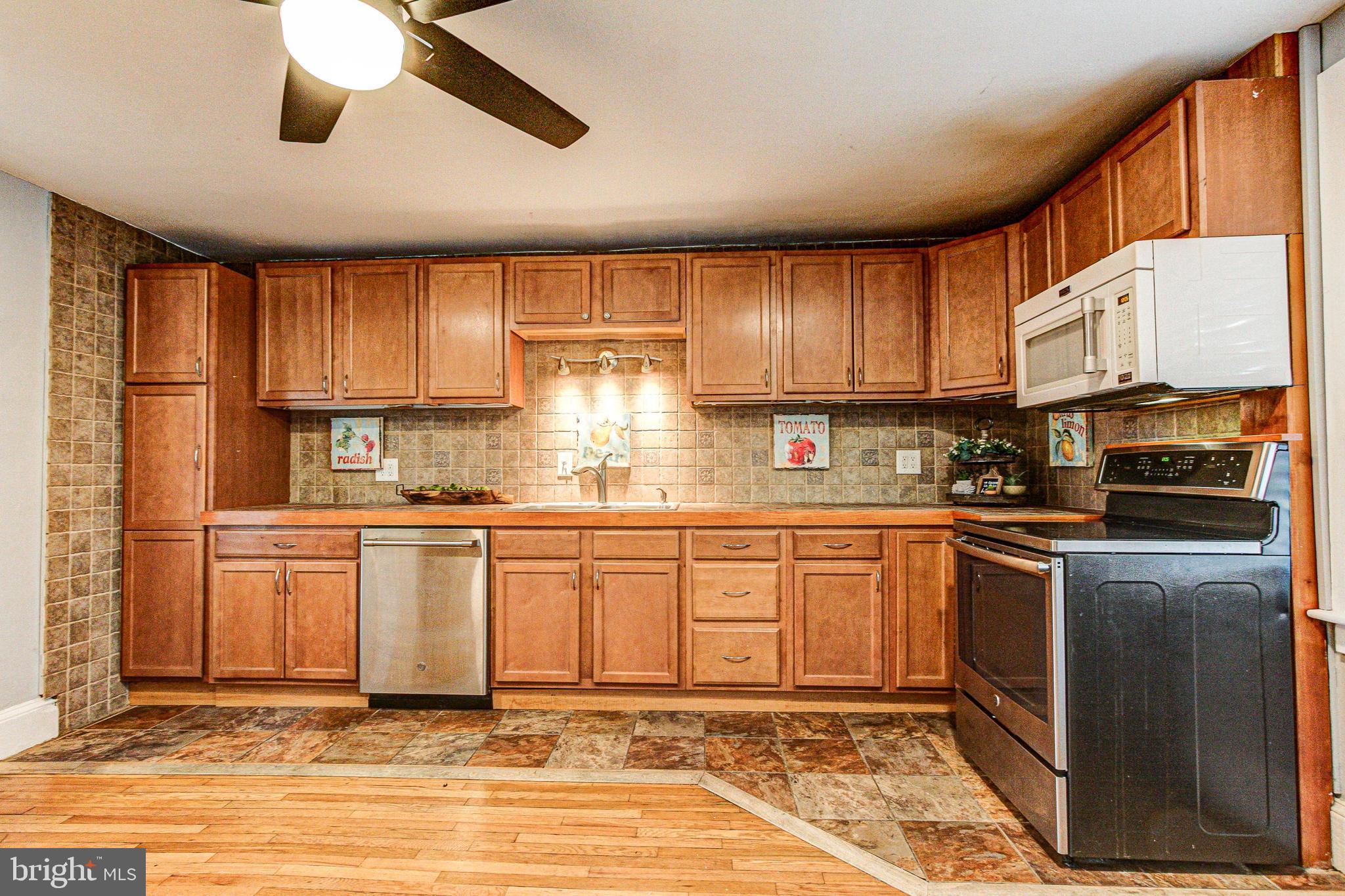 1079 Old Skippack Road Harleysville, PA 19438 - Photo 22 of 53 a kitchen with stainless steel appliances granite countertop a stove sink and cabinets