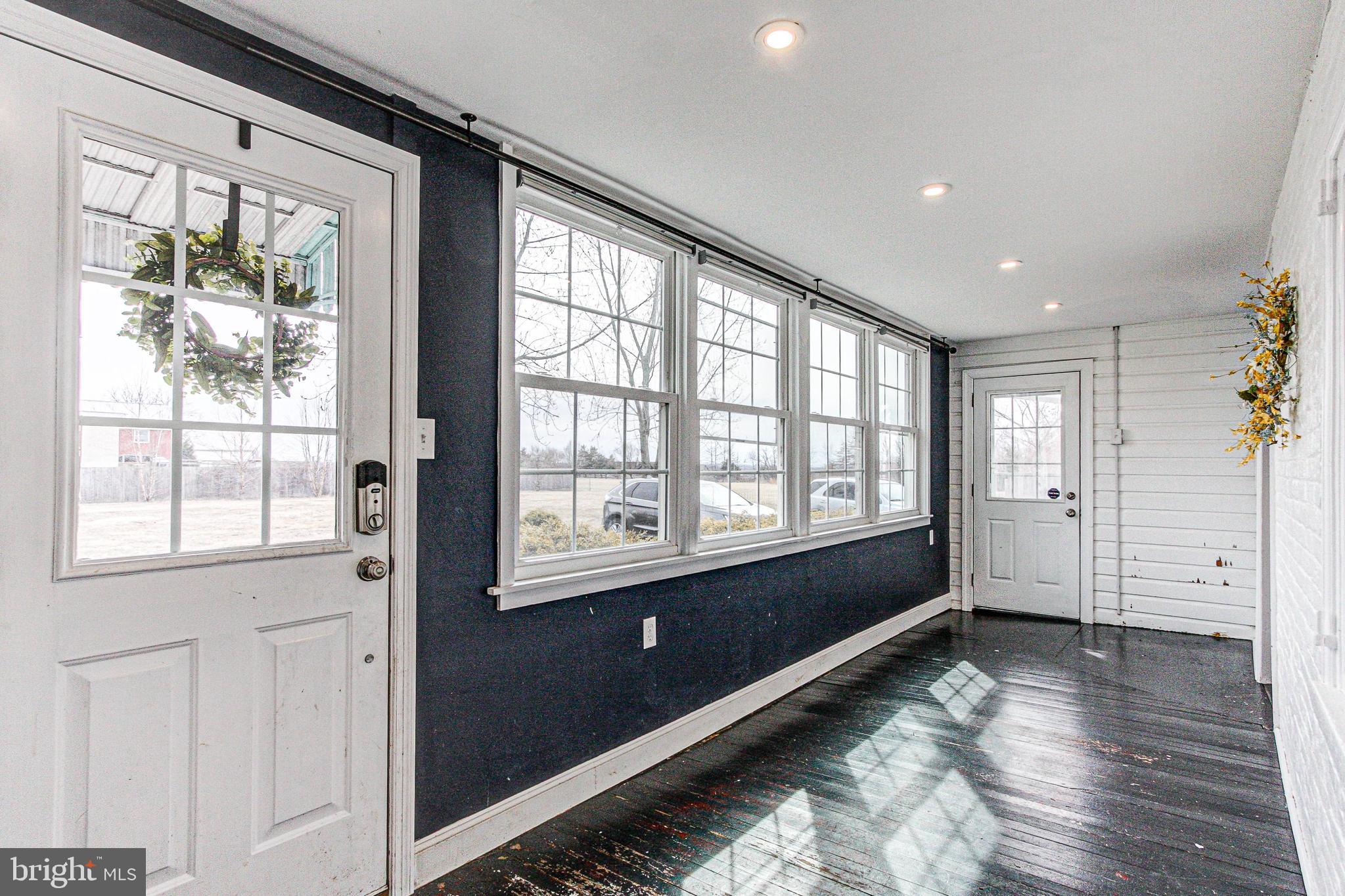 1079 Old Skippack Road Harleysville, PA 19438 - Photo 23 of 53 a view of an empty room and window and wooden floor