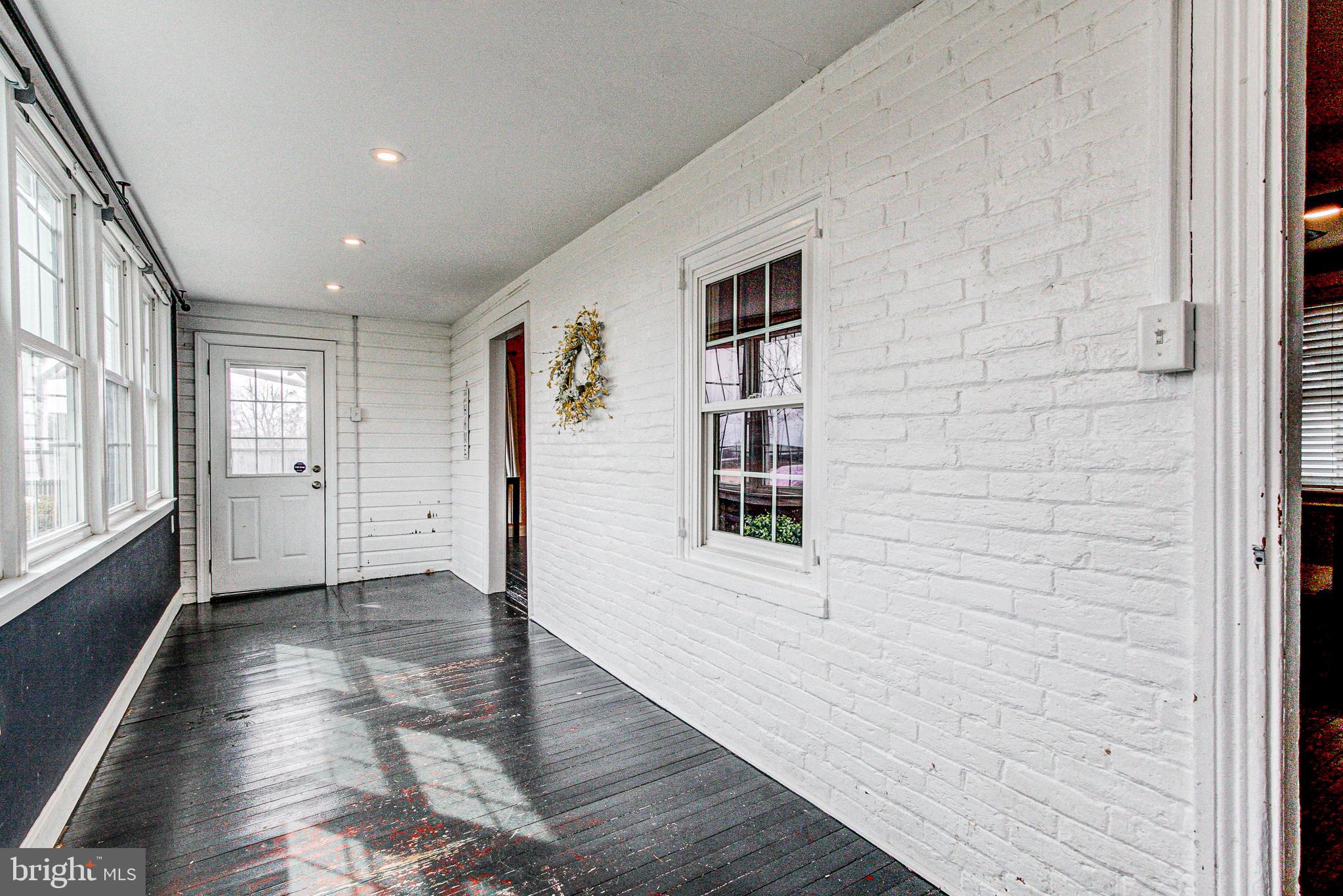 1079 Old Skippack Road Harleysville, PA 19438 - Photo 24 of 53 a view of an empty room with window and wooden floor