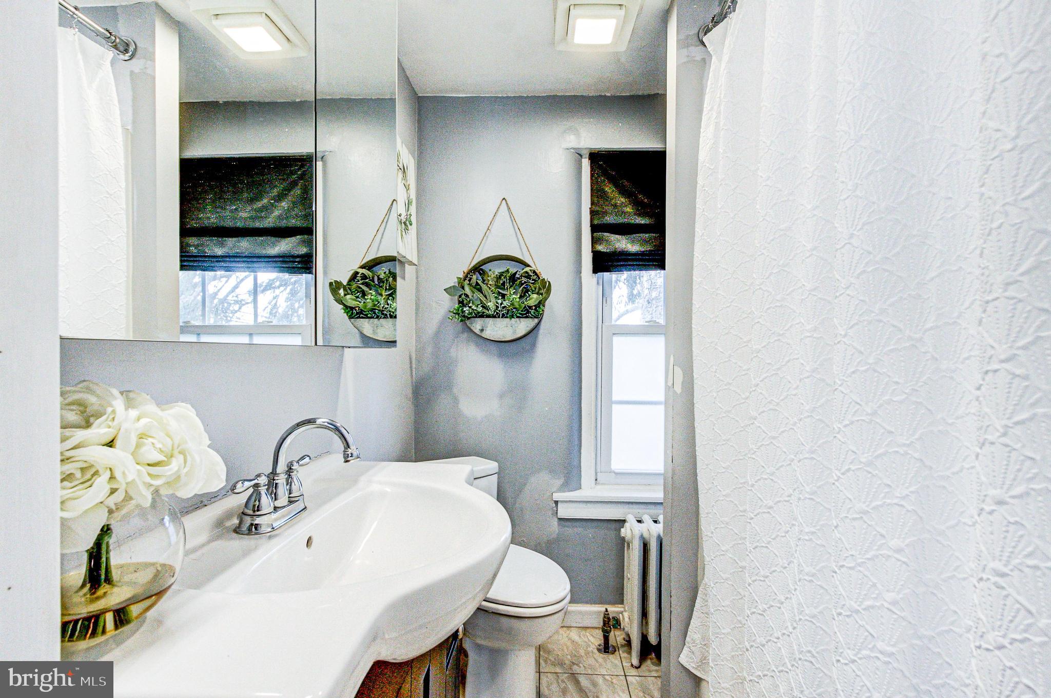 1079 Old Skippack Road Harleysville, PA 19438 - Photo 39 of 53 a bathroom with a toilet sink and mirror