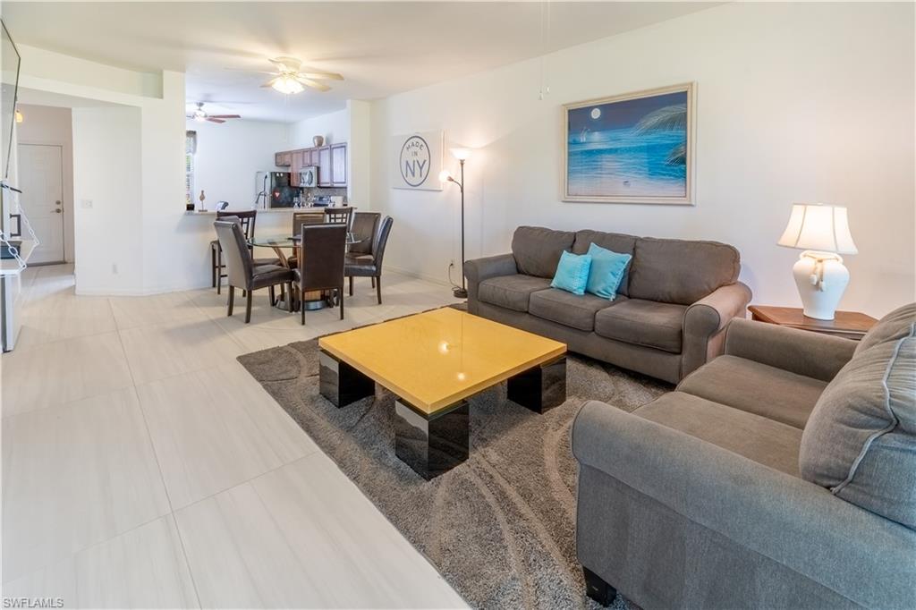 8065 Tiger Cove, Unit 1604 Naples, FL 34113 - Photo 11 of 23 a living room with furniture and wooden floor