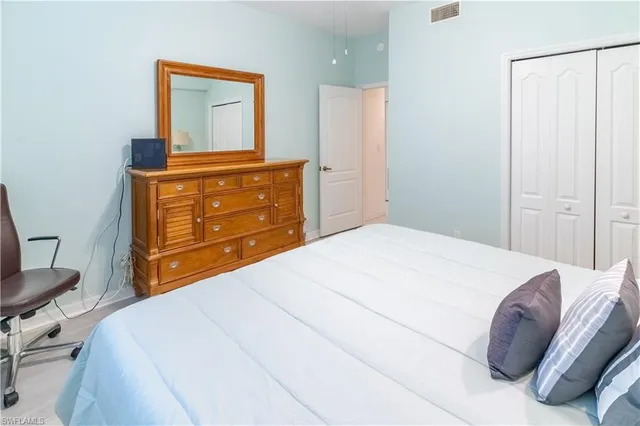 a bedroom with a bed and a dresser