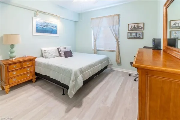 a bedroom with a bed and a desk