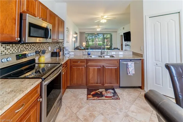 a kitchen with stainless steel appliances granite countertop a sink stove and microwave