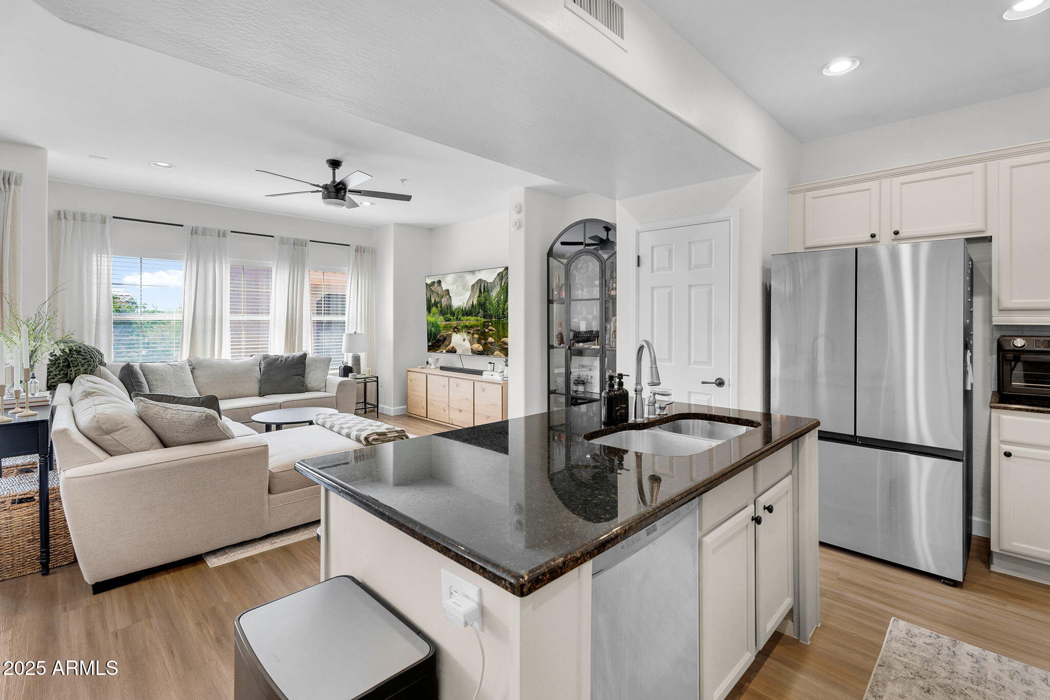 3935 East Rough Rider Road, Unit 1057 Phoenix, AZ 85050 - Photo 10 of 41 a kitchen with stainless steel appliances granite countertop a sink a refrigerator and a granite counter tops with white cabinets
