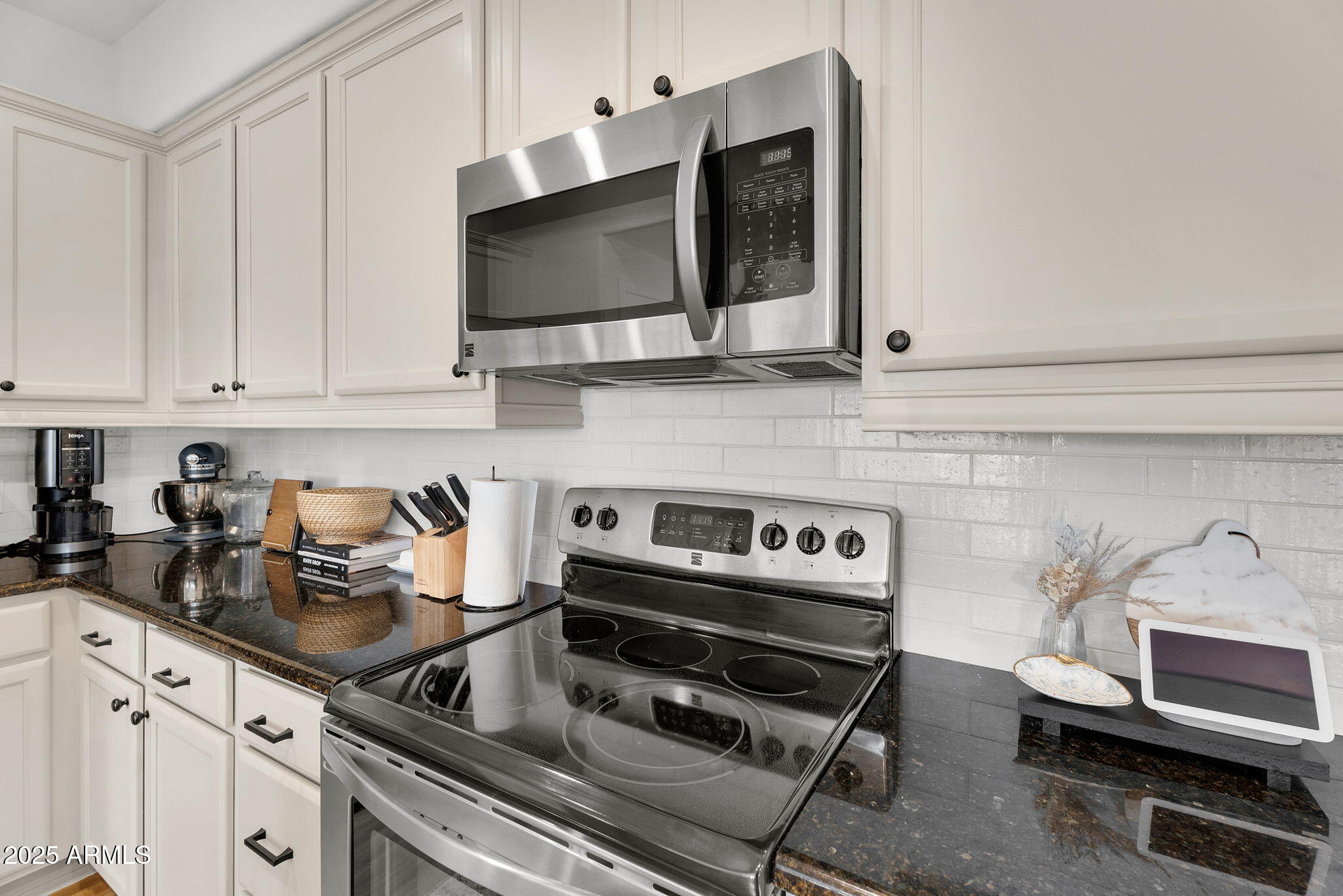 3935 East Rough Rider Road, Unit 1057 Phoenix, AZ 85050 - Photo 13 of 41 a kitchen with a stove and a microwave