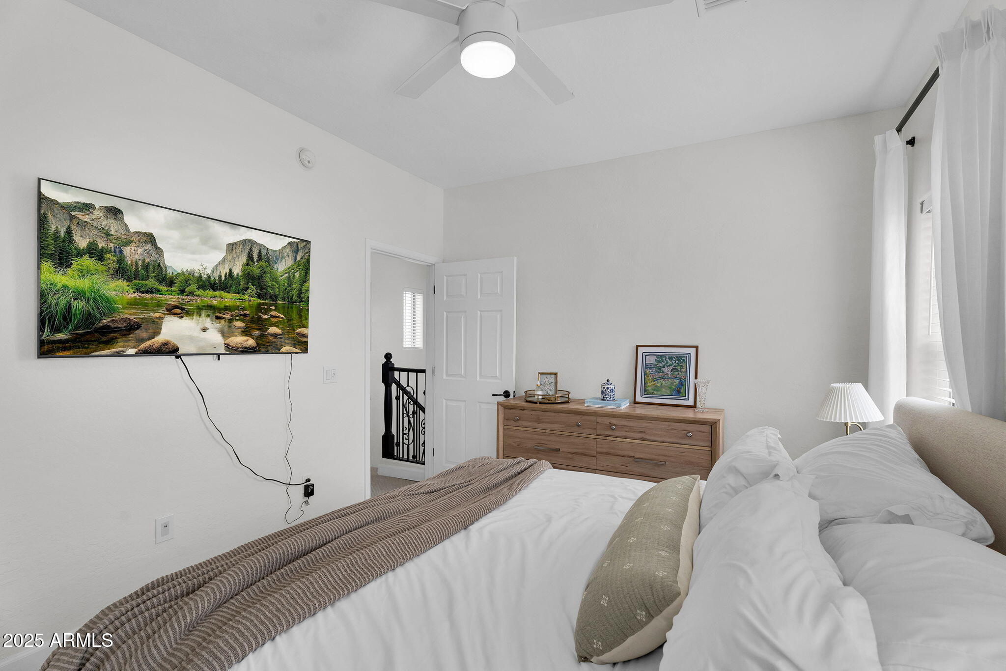 3935 East Rough Rider Road, Unit 1057 Phoenix, AZ 85050 - Photo 17 of 41 a bedroom with a bed and a flat screen tv