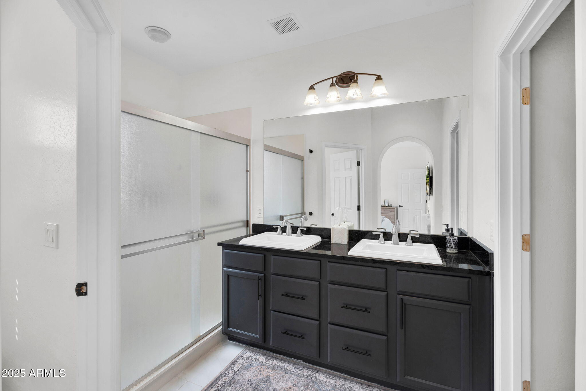 3935 East Rough Rider Road, Unit 1057 Phoenix, AZ 85050 - Photo 19 of 41 a bathroom with a double vanity sink and mirror