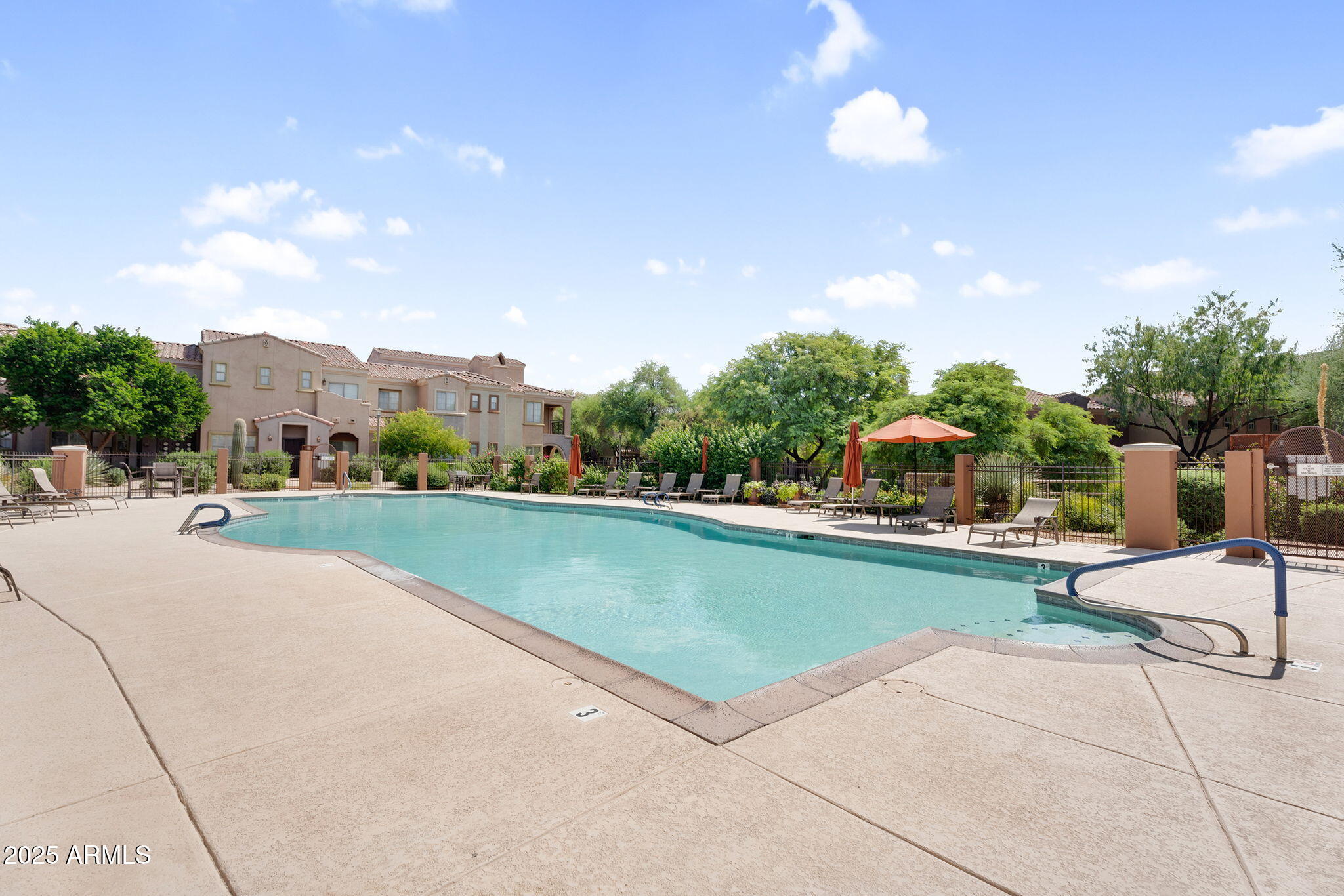 3935 East Rough Rider Road, Unit 1057 Phoenix, AZ 85050 - Photo 26 of 41 a view of swimming pool from a lounge chair