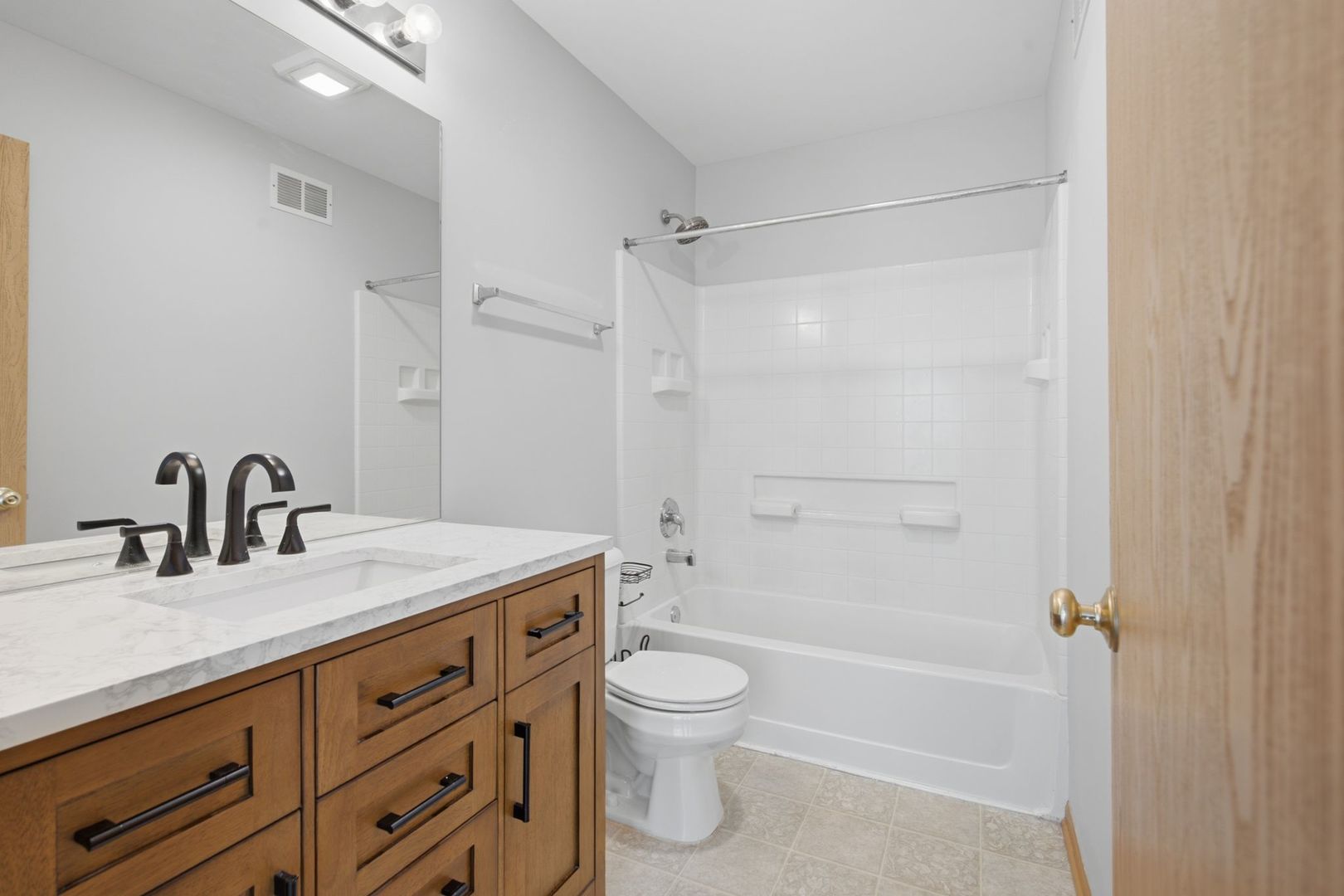 1758 Edith Lane Aurora, IL 60504 - Photo 20 of 28 a bathroom with a granite countertop sink toilet a shower and a mirror