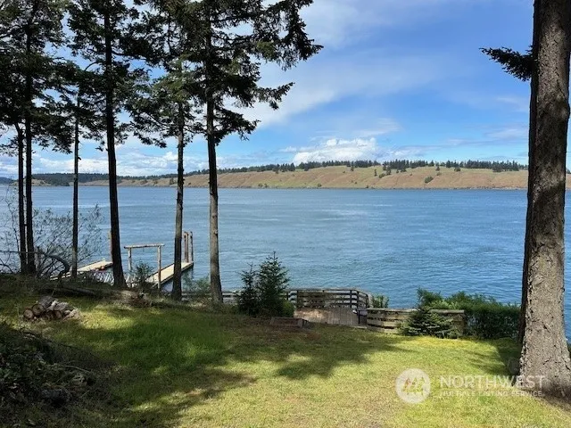 a view of a lake with lawn chairs