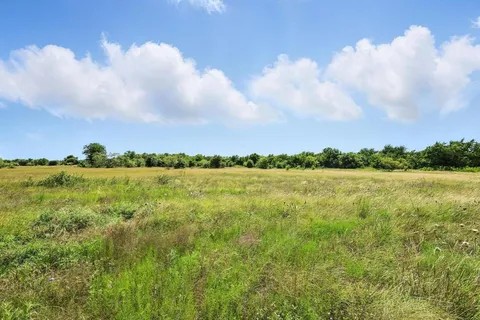a view of a lake and green valley