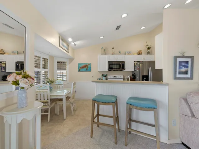 a room with stainless steel appliances kitchen island granite countertop furniture and a kitchen view