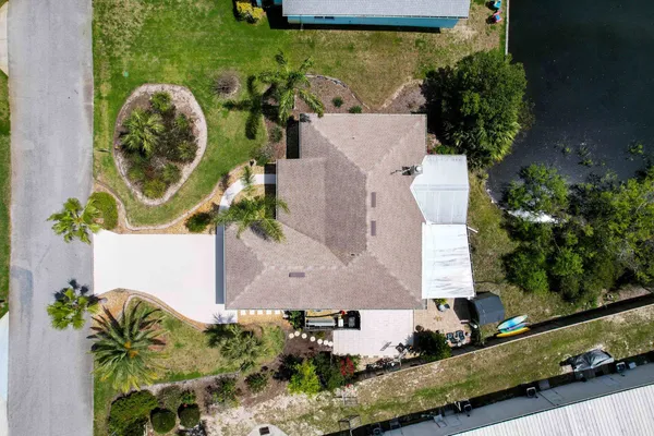 an aerial view of a house with a yard and plants