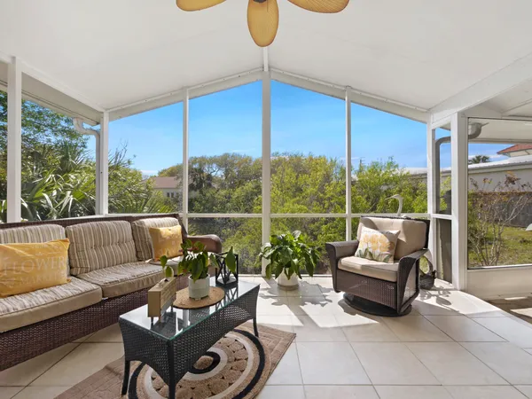 a living room with furniture and a floor to ceiling window