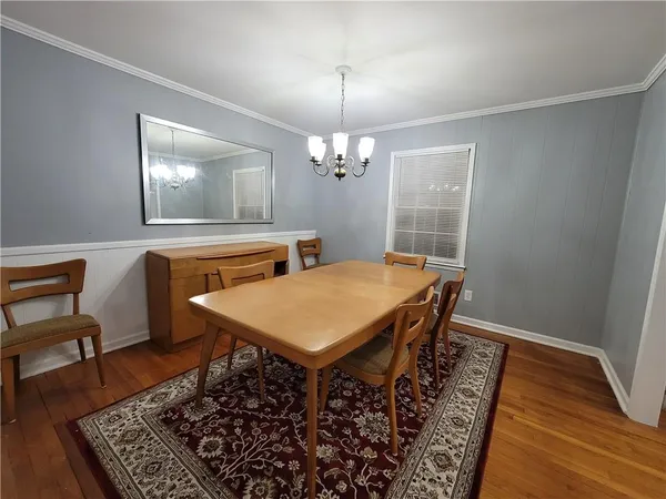 a dining room with a table chairs and a chandelier