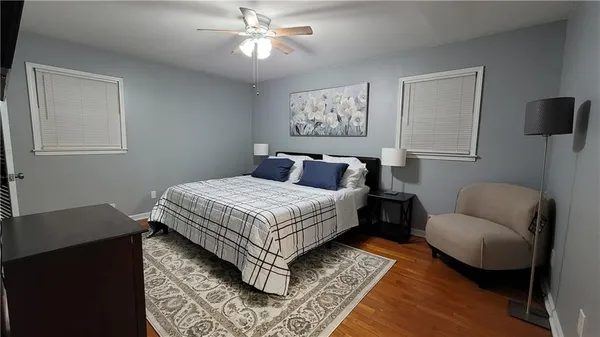 a bedroom with a large bed and a couch