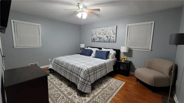 a bedroom with bed and a window