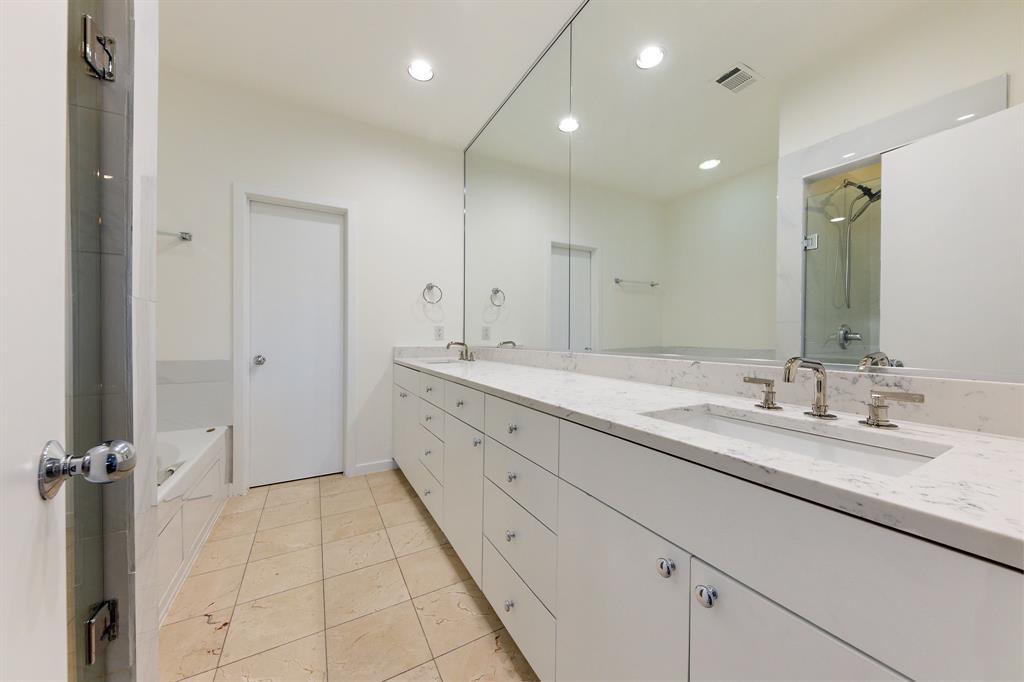 4060 Travis Street, Unit 12 Dallas, TX 75204 - Photo 13 of 20 a spacious bathroom with a granite countertop sink a mirror and a