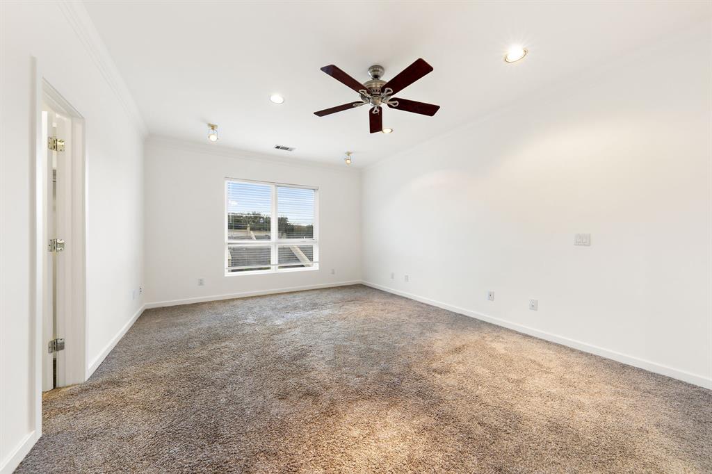 4060 Travis Street, Unit 12 Dallas, TX 75204 - Photo 17 of 20 a view of a livingroom with a ceiling fan and window