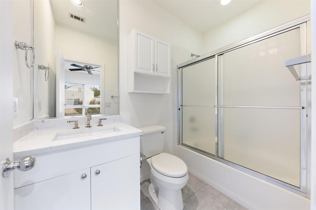 4060 Travis Street, Unit 12 Dallas, TX 75204 - Photo 19 of 20 a bathroom with a sink a toilet and shower