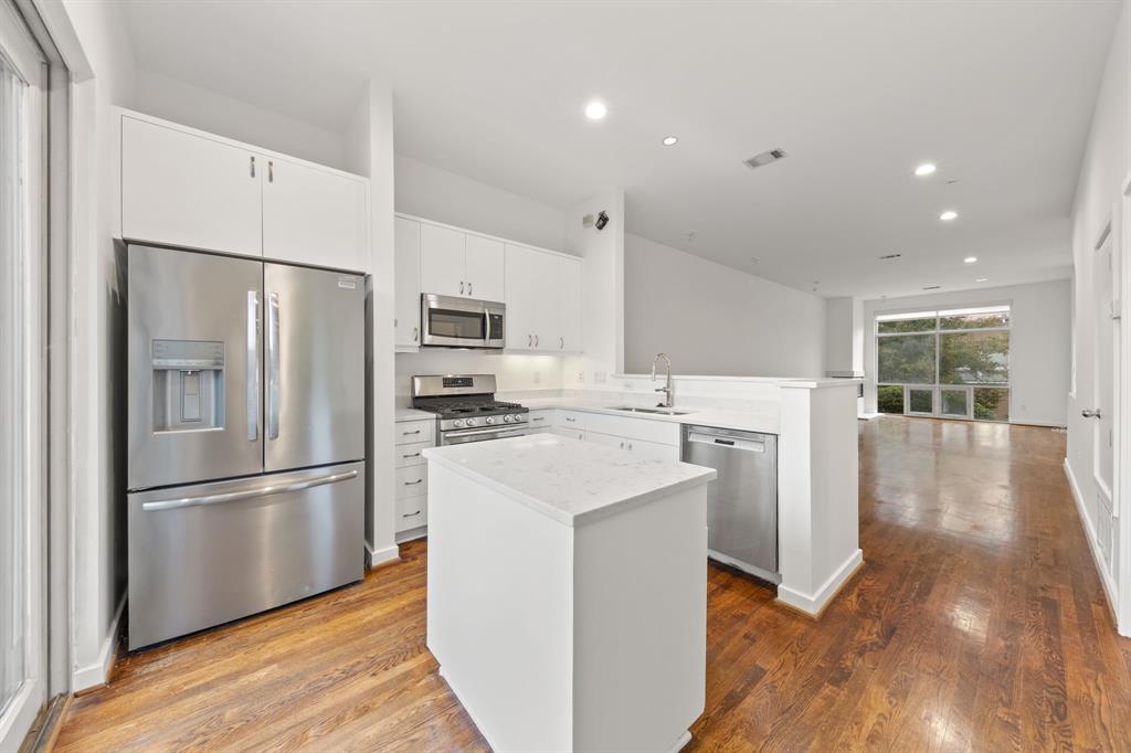 4060 Travis Street, Unit 12 Dallas, TX 75204 - Photo 3 of 20 a kitchen with stainless steel appliances a refrigerator sink and microwave