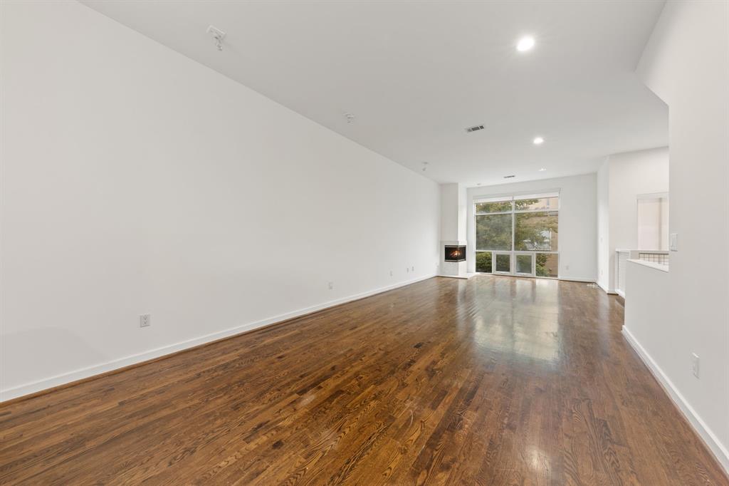 4060 Travis Street, Unit 12 Dallas, TX 75204 - Photo 8 of 20 wooden floor in an empty room with a window