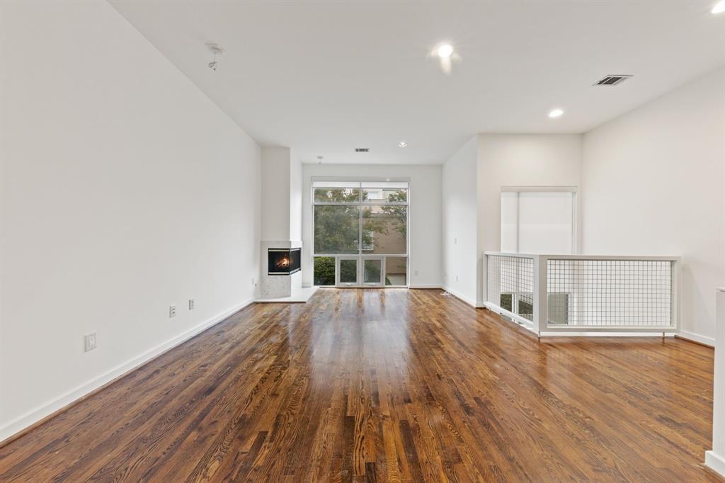 4060 Travis Street, Unit 12 Dallas, TX 75204 - Photo 9 of 20 wooden floor in an empty room with a window
