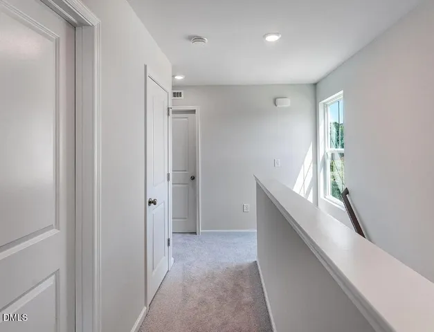 a view of entryway with window and wooden floor