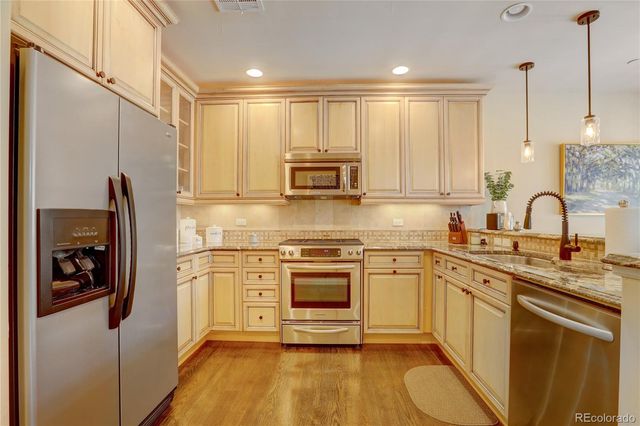 a kitchen with white cabinets and sink