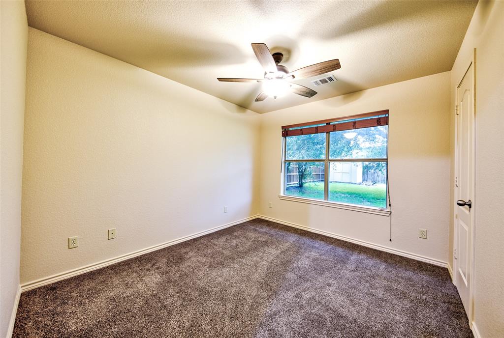 2105 Ridgewood Drive Bridgeport, TX 76426 - Photo 25 of 27 Spacious room featuring textured walls and soft grae carpeting