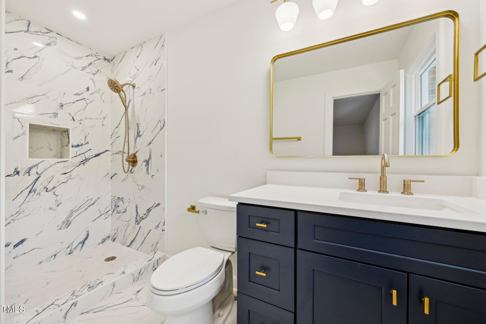 4815 Oak Park Road Raleigh, NC 27612 - Photo 22 of 50 a bathroom with a sink vanity mirror and toilet
