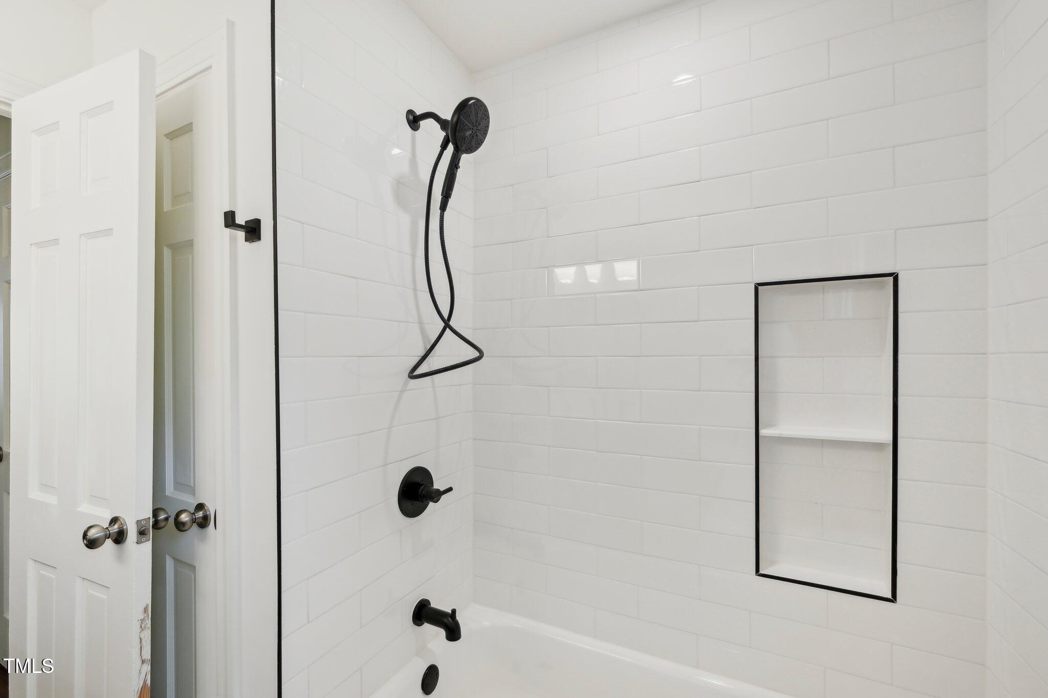 4815 Oak Park Road Raleigh, NC 27612 - Photo 23 of 50 a bathroom with a bath tub with a shower