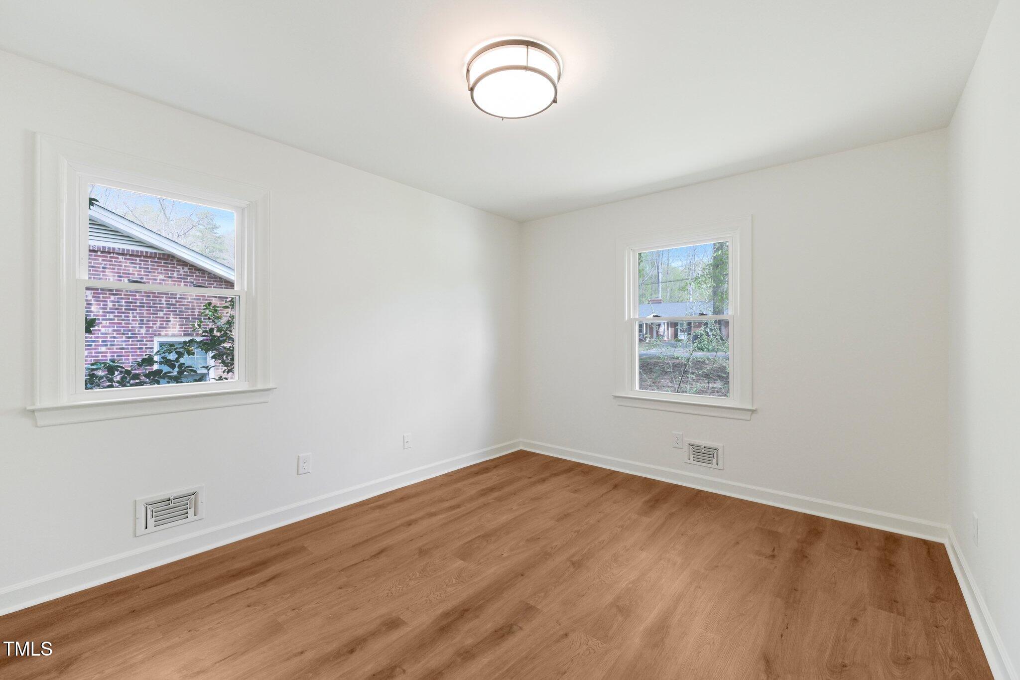 4815 Oak Park Road Raleigh, NC 27612 - Photo 31 of 50 a view of a room with wooden floor and window