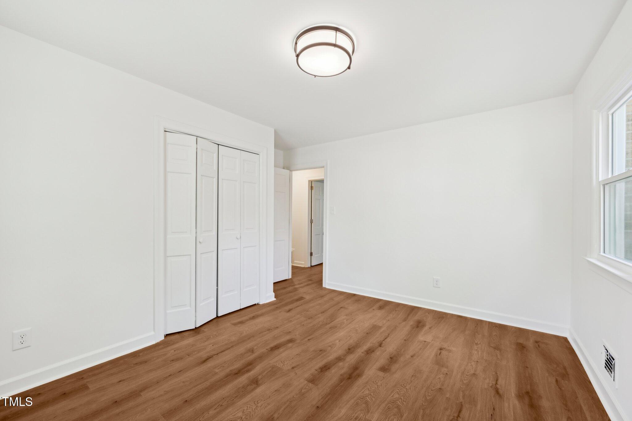 4815 Oak Park Road Raleigh, NC 27612 - Photo 32 of 50 a view of a room with wooden floor and window