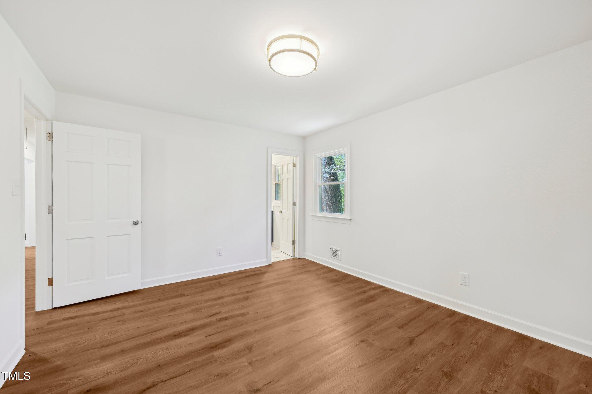 4815 Oak Park Road Raleigh, NC 27612 - Photo 34 of 50 a view of room with wooden floor and window